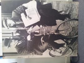 Large photograph of Alfie Byrne on bicycle buying a paper from a newsboy.