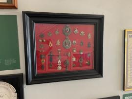 Framed Pins and Badges from Various Military Regiments